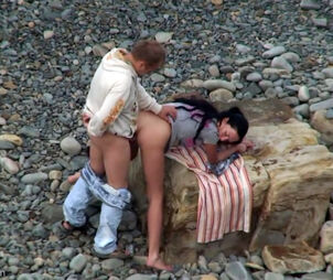 Lovely looking duo having fuck-a-thon on the remote beach